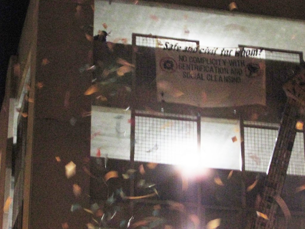 “Safe and civil for whom? No complicity with gentrification and social cleansing [crossed out City of Bloomington logo] [crossed out security camera]