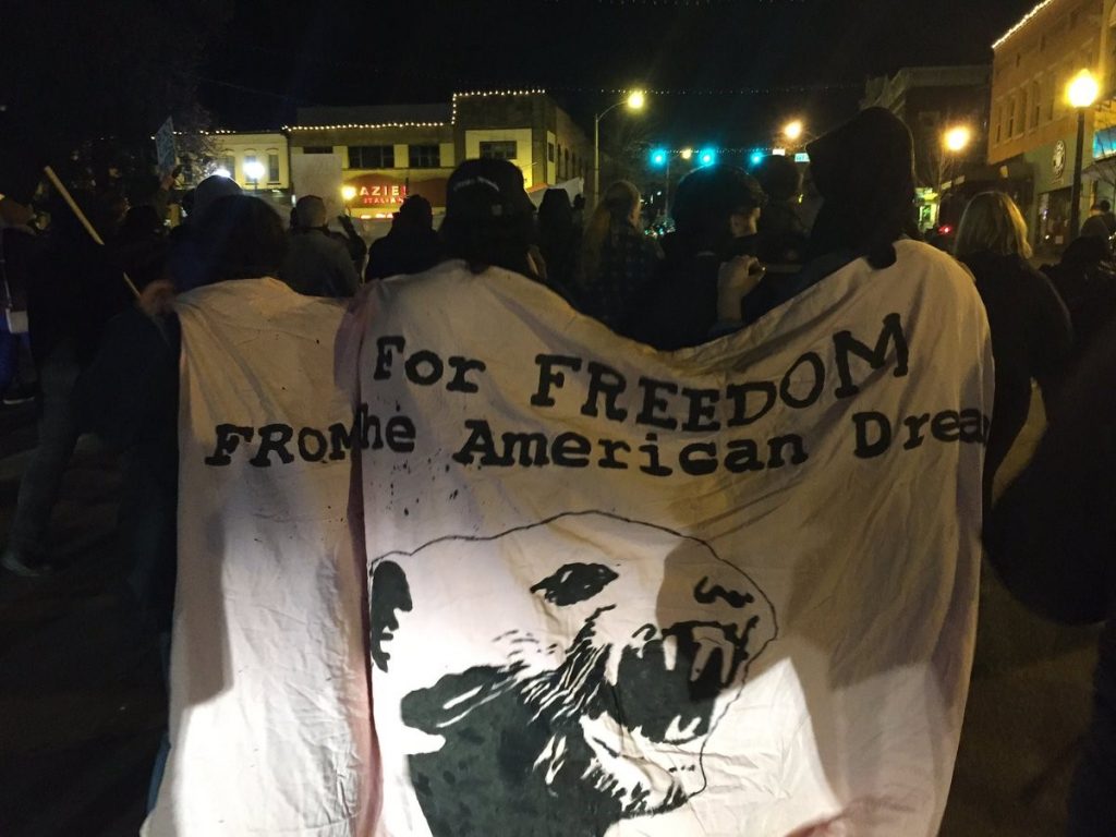 Banner reading: "For FREEDOM FROM the American Dream"
